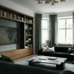 En elegant bokhylla med inbyggd TV och konst ger bokhylla inspiration till ett modernt vardagsrum med mörk soffa och gröna gardiner.